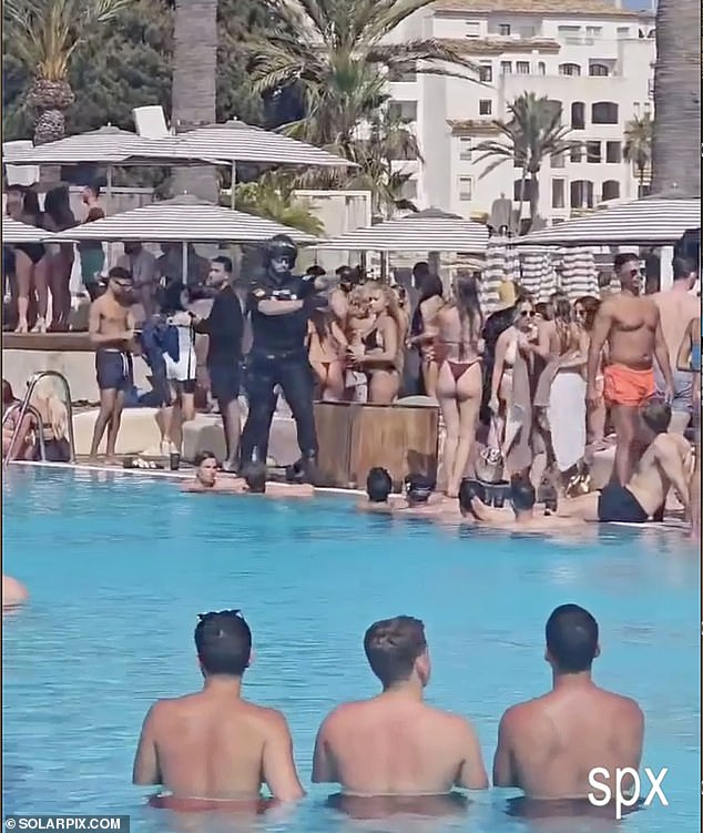 Revelers look on in shock as police storm a tourist spot after a spate of violent drug related crimes