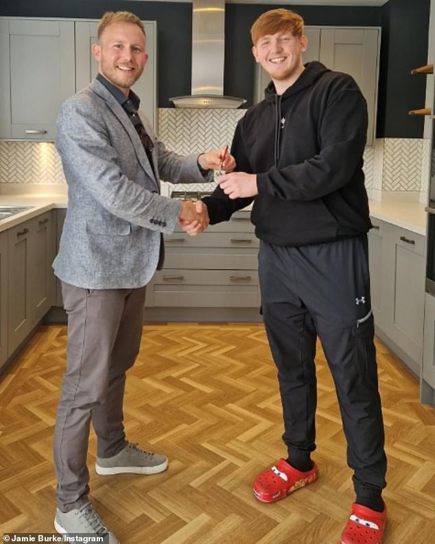 Morgan, who was raised by his mother on a council estate in Salford, still lives in Manchester but last year was able to buy his own home (pictured with estate agent Jamie Burke)
