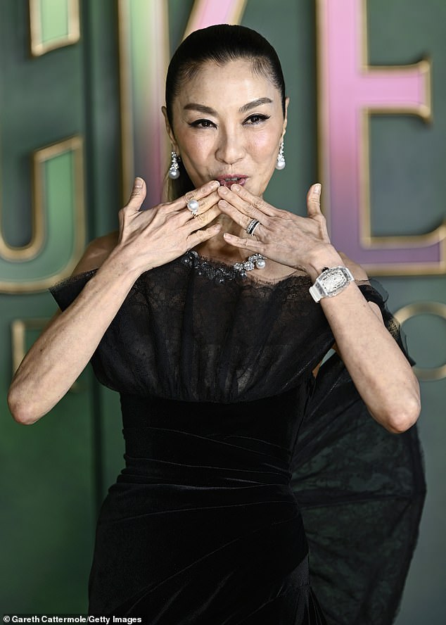 The actress, who plays the villain Madame Morrible, exuded elegance in a black satin gown with an eye-catching lace detailing