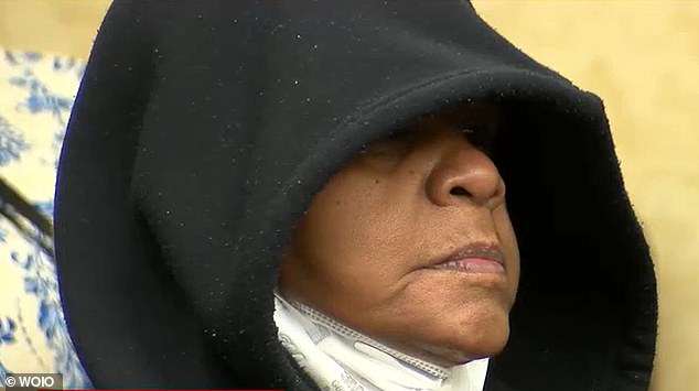 The ten-year-old girl appeared in court on Wednesday wearing a face mask and a pink coat, and was accompanied by a woman (pictured) who wore a hood over her head and walked with a cane