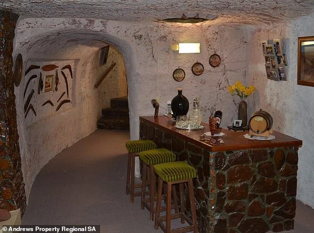 The home décor is frozen in styles popular in the 60s and 70s, including a vintage bar built from rocks