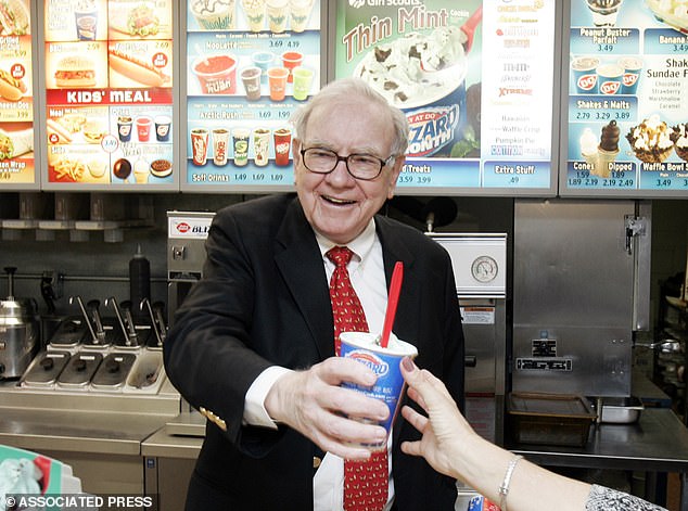 Warren Buffett hands out a Girl Scout Thin Mint Cookie Blizzard at a Dairy Queen in Omaha, Nebraska in 2008. Buffett owns Dairy Queen through his company Berkshire Hathaway, which acquired the company in 1998 for $585 million