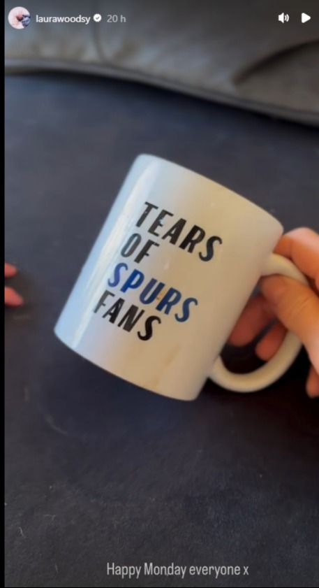 Hand holding a mug that says "Tears of Spurs Fans".