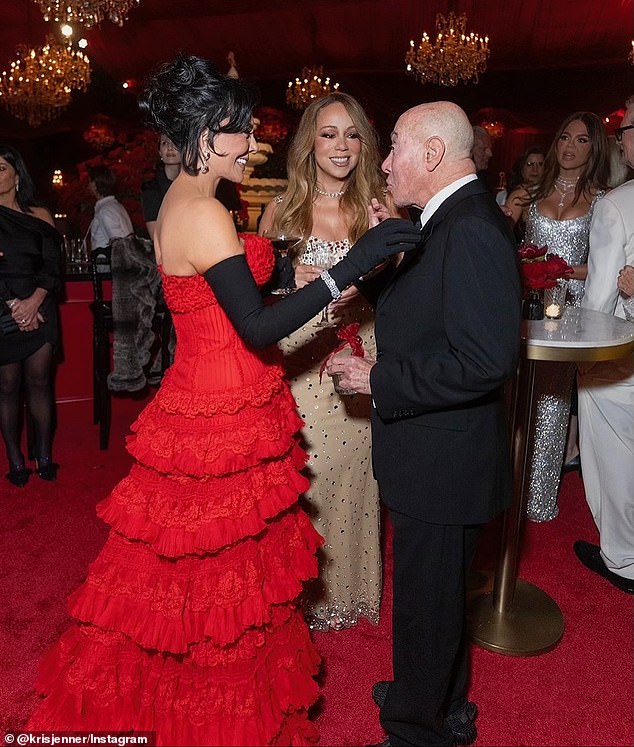 Kris looked gorgeous in her tiered red gown which she wore with long black gloves for the party (seen with Mariah)