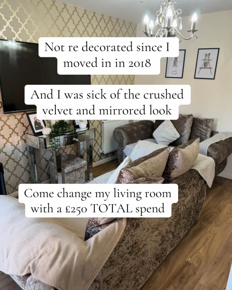 A living room with patterned wallpaper, a crushed velvet sofa, and a mirrored console table.