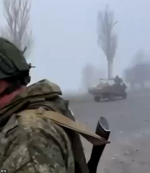 The clip showed Russian forces on motorcycles and in an odd assortment of cars and other vehicles, many stripped of doors and windows, driving along a road littered with debris as soldiers watched from the roadside