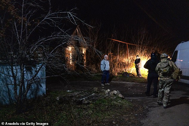 Firefighters take cover in a basement of a house due to the possible arrival of a drone in the residential area of Kramatorsk, Ukraine, on November 10, 2025