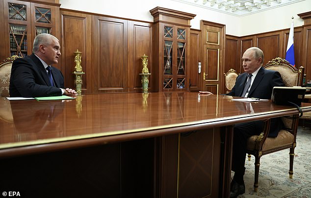Russian President Vladimir Putin (R) meets Head of the Republic of Crimea Sergei Aksyonov during a meeting at the Kremlin in Moscow, Russia, November 11 2025