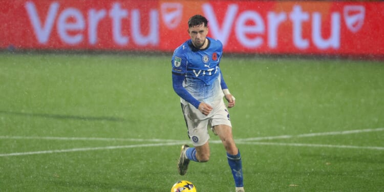 Stockport vs Wigan SUSPENDED as Vertu Trophy clash battered by torrential downpour and ball barely moving