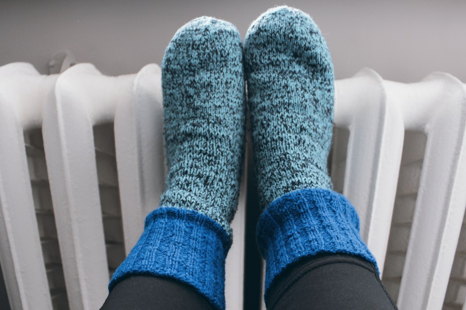 Wool socks close-up on cast iron radiators