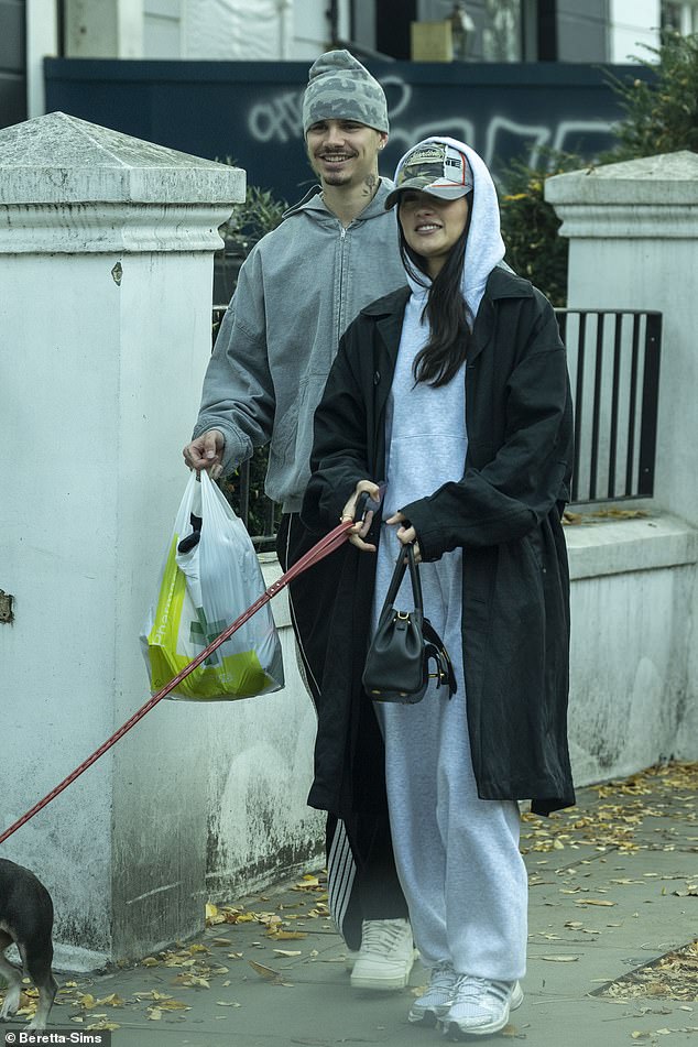 While out and about Romeo looked casual in an oversized grey hoodie and dark tracksuit bottoms