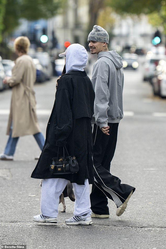 He added a beanie hat and comfortable trainers to the look