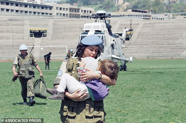 Two-year old Aldijana Mujezinovic is carried by a female UN soldier after being evacuated by helicopter from the Eastern Bosnian town of Gorazde to Sarajevo Monday April 25, 1994