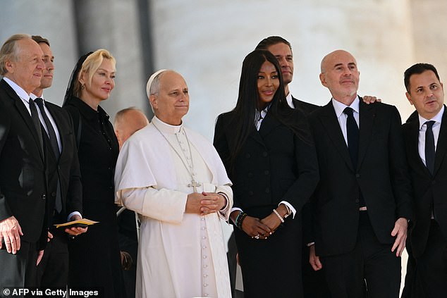Naomi wore a fitted black peplum blazer for the occasion paired with a pencil skirt and a white shirt