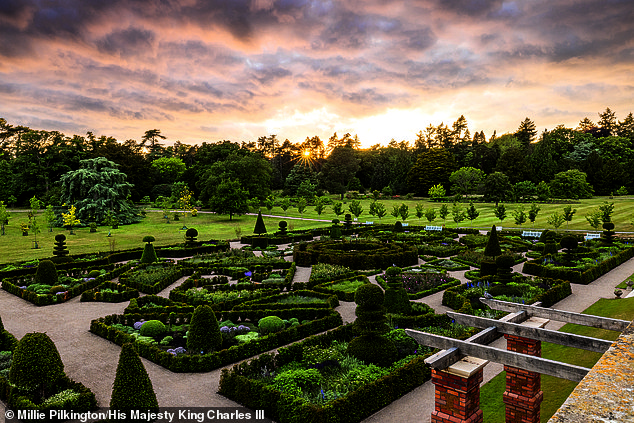 The portrait was taken in a formal part of the gardens (pictured) on the King's Norfolk estate by photographer Millie Pilkington