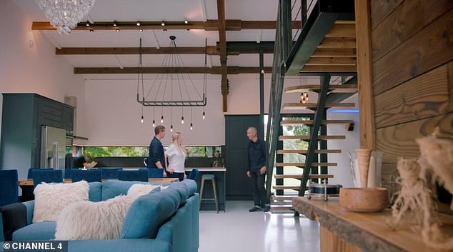 The trio are pictured walking around the double height open plan kitchen, living and dining room
