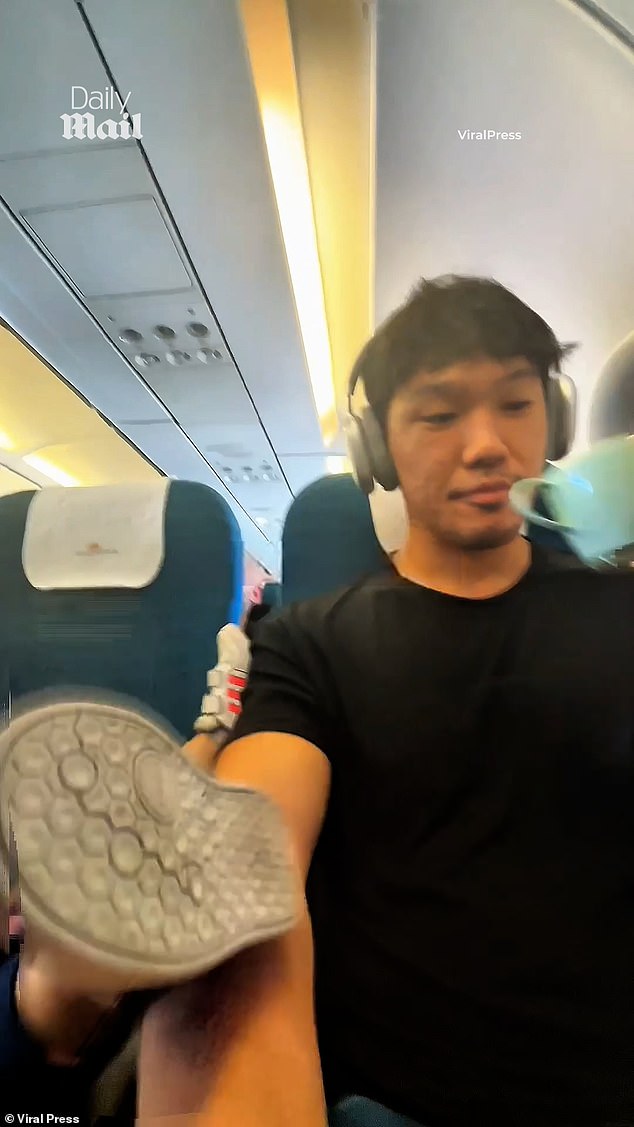 Paul, who attempted to balance his arm whilst sipping tea, stared disapprovingly at the camera for some time before flashing a polite smile to the mother - who can be heard laughing in the background