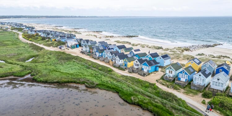 Fuming beach hut owners in UK coastal town say seaside bar is turning their home into an 'Ibiza rave scene'