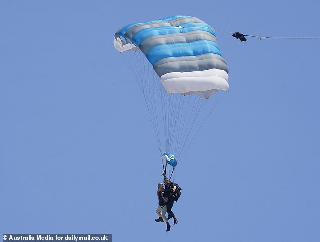 Martin looked every inch the cool customer as she arrived on the beach via parachute