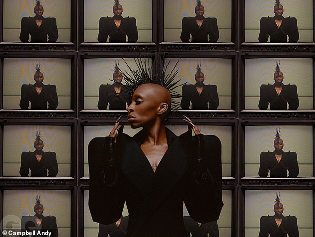 In another snap, Cynthia wore a striking black plunging neckline blouse featuring huge shoulder pads - as well as a spiky headpiece