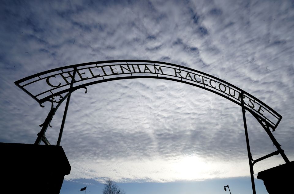Silhouette of the Cheltenham Racecourse entrance sign against a cloudy sky.