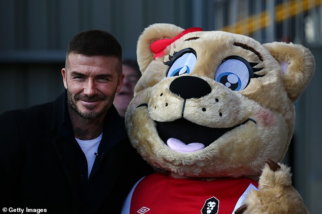 Beckham poses with the Salford City mascot. The significance of Beckham as part of the Ammies' appeal has become clear at meetings of the new ¿members club¿