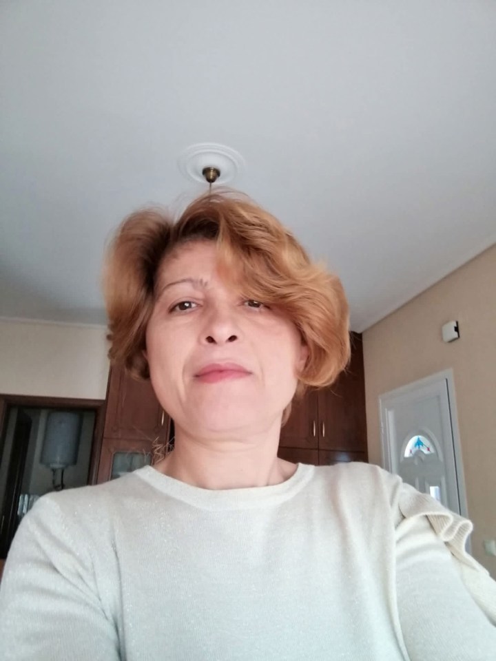 Zoe Letsiou, a 49-year-old woman with short reddish-brown hair and a light-colored top.