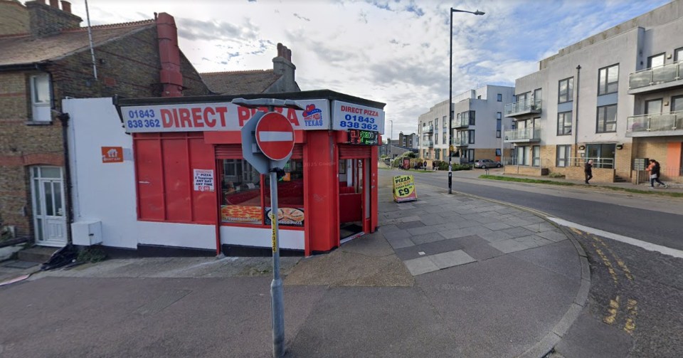 Direct Pizza and Texas takeaway shop on a street corner, with residential buildings across the street.