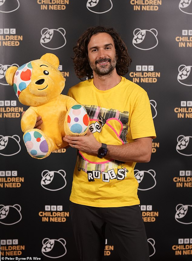 TV chef Joe, 40, was snapped as he donned a bright yellow tee while holding a Pudsey teddy bear in his arms