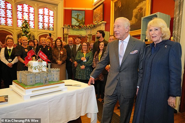 The monarch sliced into the Victoria sponge and buttercream creation, in the shape of Cyfartha Castle, watched on by the Queen, as guests including Ruth and fashion designer Julien Macdonald sang Happy Birthday