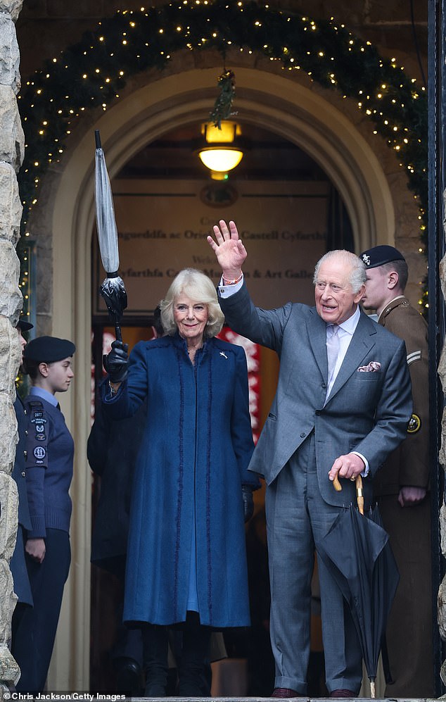 The King and Queen wave as they depart from a visit to Cyfarthfa Castle on Friday