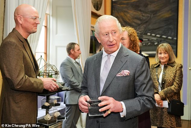 The King holds a fossil during a visit to Cyfarthfa Castle in Merthyr Tydfil, South Wales, for a celebratory reception marking the Castle's 200th anniversary and the King's 77th birthday
