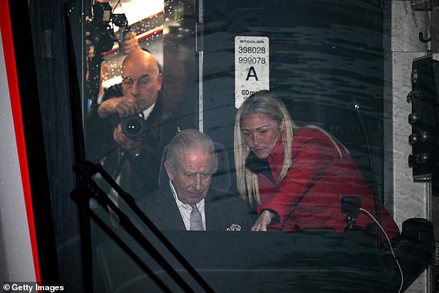 Charles takes the controls of a tram-train officially named Myddfai within the depot