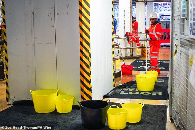 Buckets collect rain water in Paddington station in London as the capital faces downpours