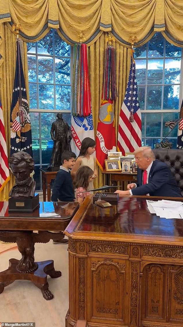 Amid the fallout, young children were seen surrounding the President in a tender moment caught on video in the Oval Office