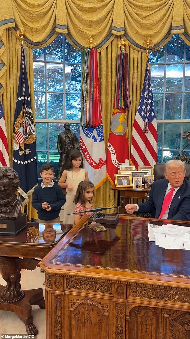 The children could be seen laughing as the president hands them gifts inside the Oval Office