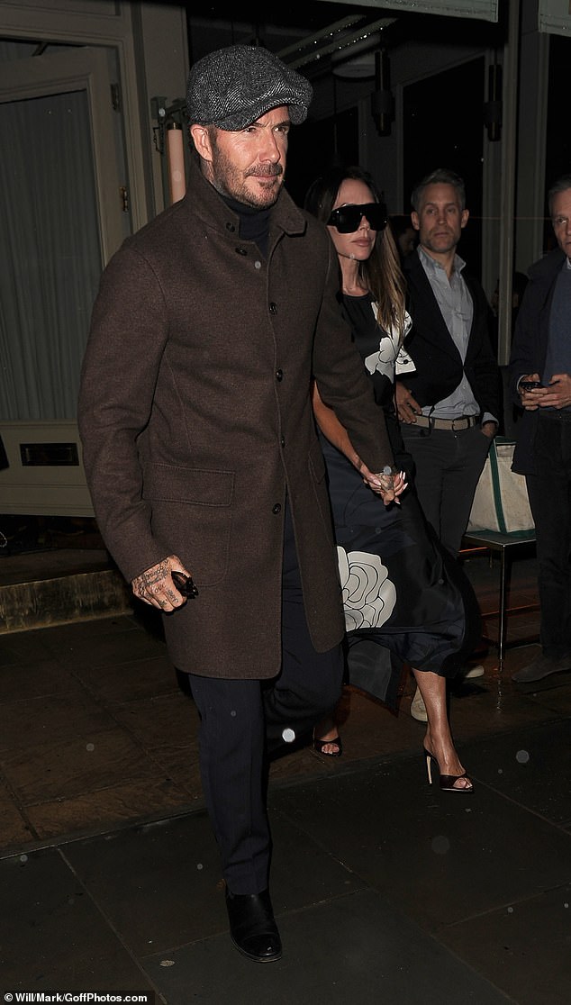 He layered his outfit with a black turtleneck jumper and a smart pair of navy trousers