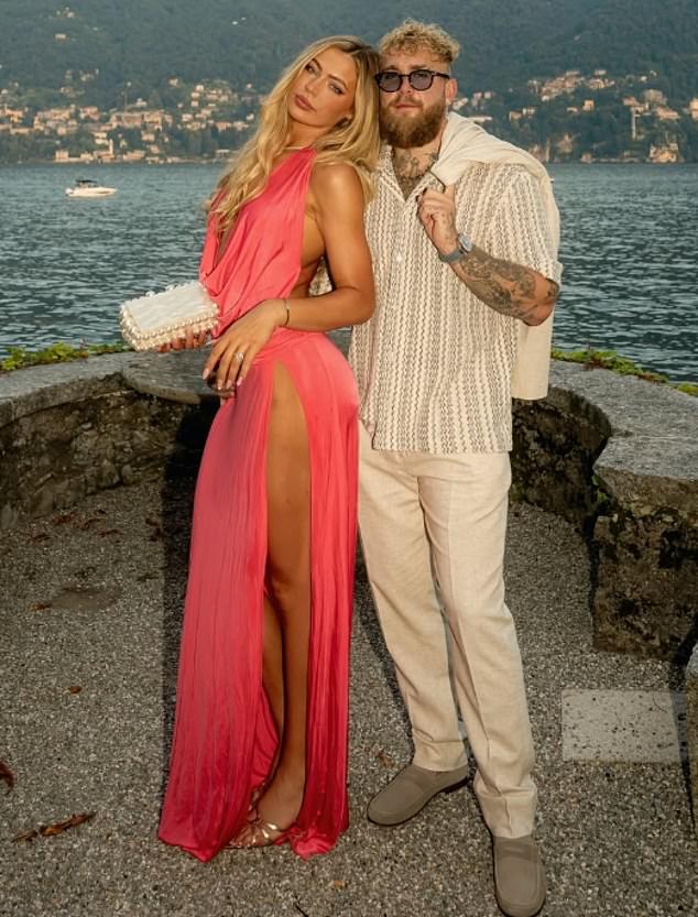 The couple are pictured by Lake Como in a recent snap after he proposed