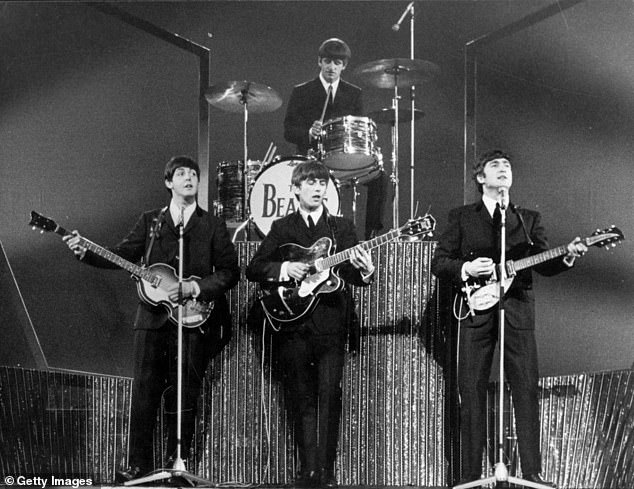 The Beatles on stage at the London Palladium during a performance in front of 2, 000 screaming fans in 1963