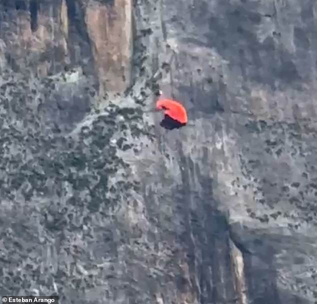 Amazingly, his parachute opens just seconds from impact - jarred loose from its damaged container by the collision