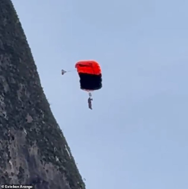 The daredevil is then seen slumped in his harness, dangling helplessly in mid-air as the person filming says, 'He's dead