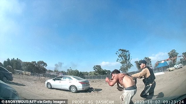 Pictured: An armed Palestinian militant leading a man away during the Supernova music festival