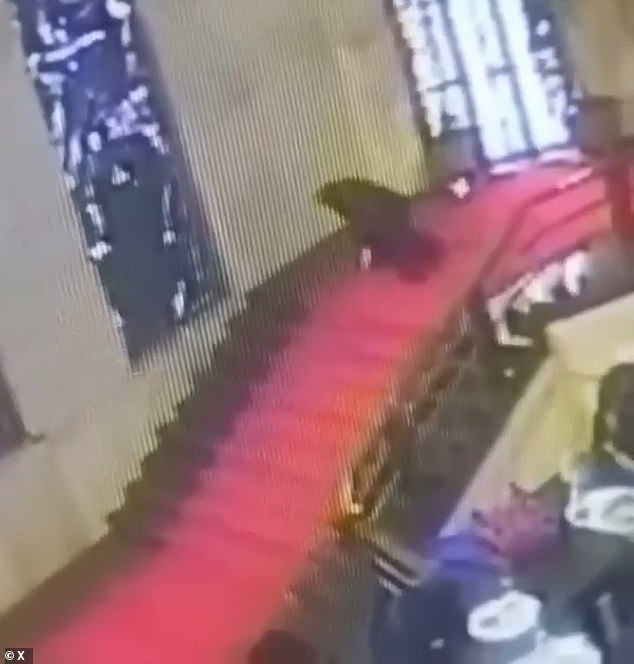 Cani desperately tries to regain his balance, but is unsuccessful and hurtles towards the 'Labour Charter,' a work by the futurist artist Mario Sironi