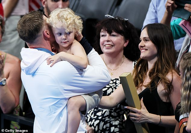 Pictured, Adam Peaty celebrates his 2024 Paris Olympic medal win with his son George, his mother Caroline and Holly
