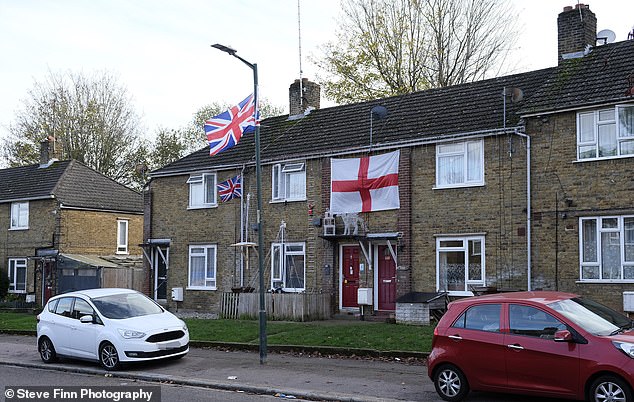 A house in Medway where flags are still flying after the council spent £11,500 removing them