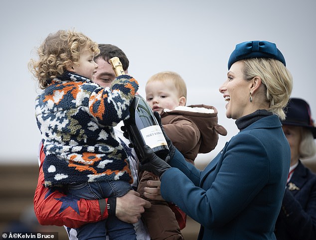 The 44-year-old daughter of Princess Anne was photographed presenting jockey James King with a bottle of Moët Champagne after his victory in the Debenhams Amateur Jockeys’ Handicap Chase