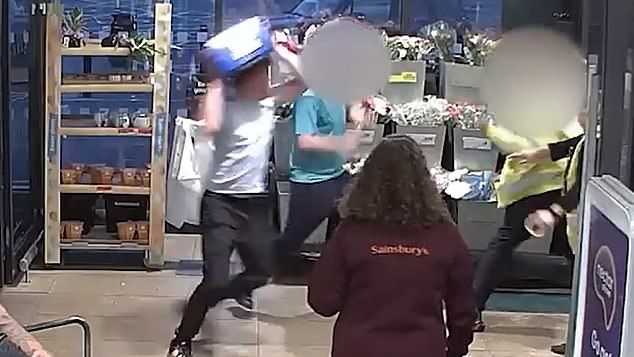 The teen is later seen throwing punches and a crate of beer at the security guard