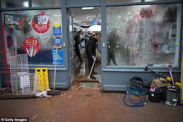 Residents and business owners begin the clean up after yesterday's floods