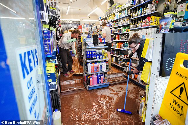 Staff rally together to clean up their store in Monmouth after Storm Claudia brought floods