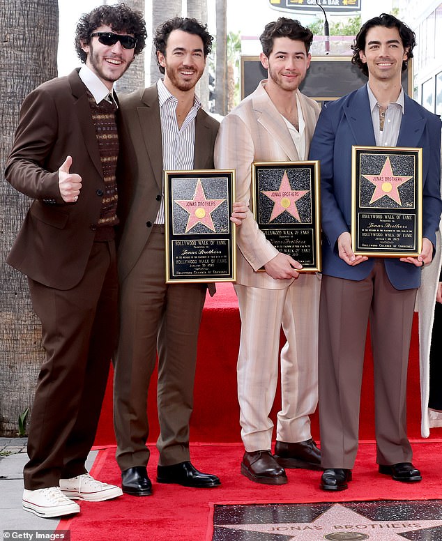 The Jonas Brothers band is famously a trio, so many would be surprised to know there's actually a fourth Jonas brother, Frankie, who fans affectionately refer to as the 'Bonus Jonas' (L-R Frankie, Kevin, Nick and Joe Jonas in 2023)